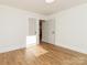 Well-lit bedroom with hardwood floors and access to other rooms at 138 Pounds Sw Ave, Concord, NC 28025