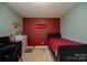 Small bedroom with a twin bed and maroon walls at 1735 Herndon Farm Rd, Rock Hill, SC 29732