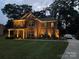 Brick two-story house with warm lighting at night at 1735 Herndon Farm Rd, Rock Hill, SC 29732