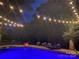 Blue-lit pool at night with string lights and seating at 1735 Herndon Farm Rd, Rock Hill, SC 29732