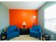 Cozy sitting area with two blue armchairs and orange accent wall at 1735 Herndon Farm Rd, Rock Hill, SC 29732