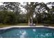 Relaxing pool with surrounding patio and trees at 1735 Herndon Farm Rd, Rock Hill, SC 29732