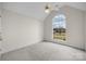 Bedroom with large arched window and ceiling fan at 2802 Tara Dr, Monroe, NC 28112