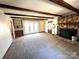 Living room with stone fireplace and built-in shelving at 36954 Tercher Rd, New London, NC 28127