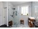 Modern bathroom with a large walk-in shower, built-in shelving, and a window at 6635 Old Magnolia Ln, Mint Hill, NC 28227