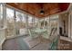 Screened porch with glass top table and seating area at 6906 Red Maple Dr, Charlotte, NC 28277