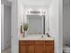 Bathroom vanity with wood cabinets and a large mirror at 7148 Abbotts Glen Dr, Charlotte, NC 28212