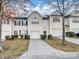 Cream-colored townhome with a two-car garage and landscaping at 7148 Abbotts Glen Dr, Charlotte, NC 28212