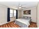Bedroom with double bed, ceiling fan, and navy curtains at 8327 Walkup Rd, Waxhaw, NC 28173