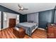 Cozy bedroom with dark blue walls, ceiling fan, and ample closet space at 8327 Walkup Rd, Waxhaw, NC 28173
