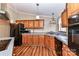 Kitchen with ample wood cabinetry, updated flooring, and stainless steel appliances at 8327 Walkup Rd, Waxhaw, NC 28173