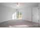 Bright bedroom with gray carpet, sliding door to deck access at 1934 Hickory Hills Dr, Denver, NC 28037