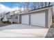 Three-car garage with a gray exterior and white doors at 1934 Hickory Hills Dr, Denver, NC 28037