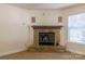 Stone fireplace with brass fire tools in the living room at 2138 Durand Rd, Fort Mill, SC 29715