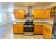 Kitchen with wood cabinets, stainless steel appliances, and tile flooring at 2138 Durand Rd, Fort Mill, SC 29715