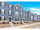 Modern townhouses with gray siding, brown shutters and landscaping at 2407 Autumn Olive Ln, Stallings, NC 28104