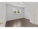 Simple bedroom with hardwood floors and neutral walls at 304 Shady Ln, Norwood, NC 28128