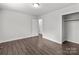 Spacious bedroom featuring wood-look floors and ample closet space at 304 Shady Ln, Norwood, NC 28128