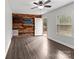 Living room with wood-look floors, and a rustic accent wall at 304 Shady Ln, Norwood, NC 28128