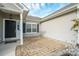 Brick and vinyl-sided home with a covered entry and stone patio at 5315 Hackberry Sw Ln, Concord, NC 28027