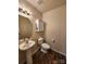 Clean half bathroom, pedestal sink, toilet, and white cabinet at 7917 E Lane Dr # 64, Charlotte, NC 28212