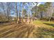 Backyard view showing a large grassy area and trees at 800 Peachtree Rd, Charlotte, NC 28216