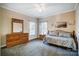 Cozy bedroom with wood dresser and daybed, featuring ample natural light at 952 Hummingbird Ln, Rock Hill, SC 29732