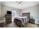 Well-lit bedroom with a striped bed and dark wood furniture at 952 Hummingbird Ln, Rock Hill, SC 29732