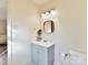 Simple bathroom with a gray vanity and a modern mirror at 10035 Little Creek Rd, Mint Hill, NC 28227