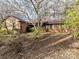 Ranch style brick home with a covered porch and landscaped yard at 10035 Little Creek Rd, Mint Hill, NC 28227