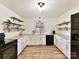 Modern kitchen with white cabinets, L-shaped counter, and stainless steel appliances at 10035 Little Creek Rd, Mint Hill, NC 28227