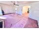 Living room with pink carpet and access to other rooms at 1030 13Th St, Hickory, NC 28602