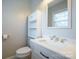 Small bathroom with toilet, sink, and over-the-toilet storage at 104 Barbee Sw Rd, Concord, NC 28027