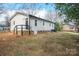 Rear view of house showing exterior door and yard at 104 Barbee Sw Rd, Concord, NC 28027