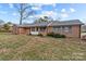 Ranch style brick house with blue shutters and a large yard at 116 Cherokee Se Dr, Concord, NC 28025