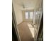 Bright bedroom with neutral carpeting and two windows at 14243 Richmond Park Ave, Charlotte, NC 28277