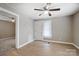 Living room with hardwood floors, ceiling fan, and access to bedrooms at 1428 W Wilson Lee Blvd # 9, Statesville, NC 28677