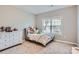 Charming bedroom with a dresser and window, perfect for a  at 14716 Murfield Ct # Lot 6, Charlotte, NC 28278