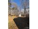 Backyard with shed, wood pile, and mature trees at 1830 Light Brigade Dr, Matthews, NC 28105