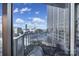 Balcony with city views and a chair; building and street scenes visible at 210 N Church St # 1213, Charlotte, NC 28202