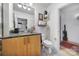 Bathroom with granite countertop, wood cabinets, and a toilet at 210 N Church St # 1213, Charlotte, NC 28202