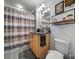 Striped shower curtain and granite countertop vanity in this full bathroom at 210 N Church St # 1213, Charlotte, NC 28202