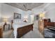 Bright bedroom with a wooden sleigh bed, dresser, and ceiling fan at 210 N Church St # 1213, Charlotte, NC 28202