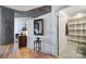 Entryway with wood floors, a small table, and access to bathroom and bedroom at 210 N Church St # 1213, Charlotte, NC 28202