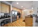 Modern kitchen with stainless steel appliances and light wood cabinets at 210 N Church St # 1213, Charlotte, NC 28202