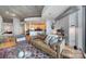 Spacious living room features a leather sofa and decorative rug, with a kitchen and dining area visible at 210 N Church St # 1213, Charlotte, NC 28202