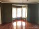 Bedroom with hardwood floors, bay window, and dark green walls at 310 E Church St, Troutman, NC 28166