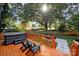 Deck with hot tub, patio furniture, and large backyard at 4122 Applegate Rd, Charlotte, NC 28209