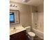 Clean bathroom with a tub shower combo, toilet and vanity at 104 Lassiter Ct, Mount Holly, NC 28120