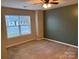 Bright bedroom featuring a large window and ceiling fan at 104 Lassiter Ct, Mount Holly, NC 28120